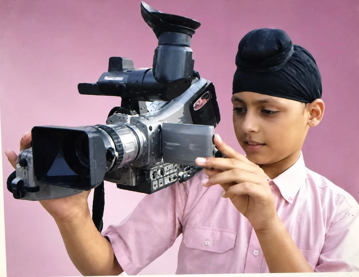 Jovanpreet as a child holding a video camera
